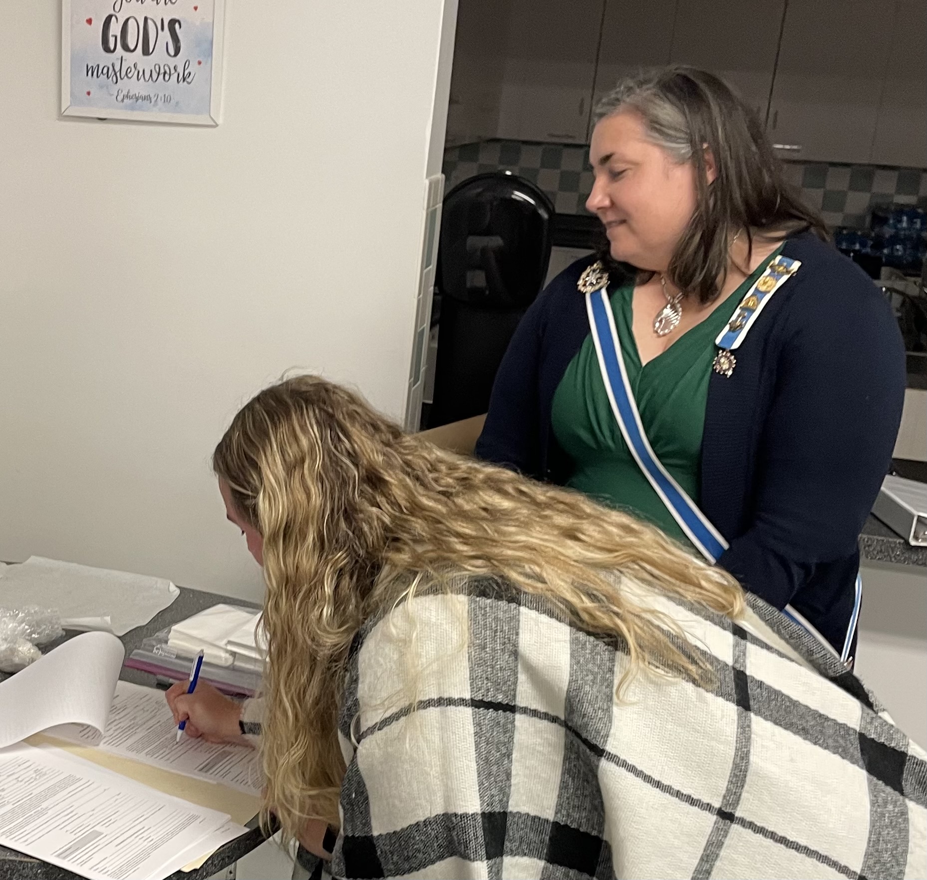 New member signing her application